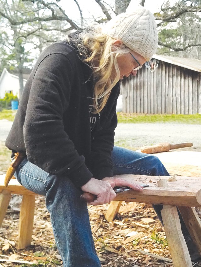 Festival organizer Cara O'Connell shown practicing the art of woodworking.