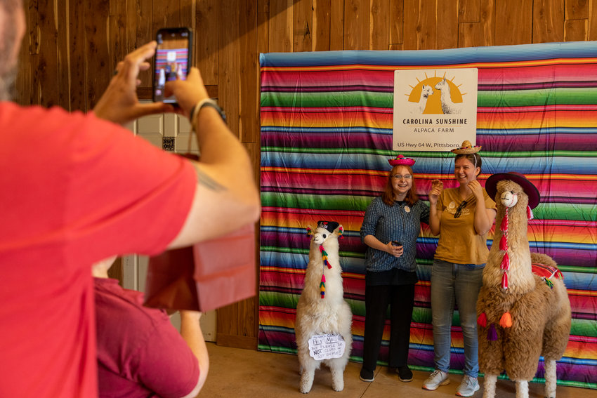 Visitors pose for a picture at Carolina Sunshine Alpaca Farm's grand opening event. Attendees also had the opportunity to participate in arts and craft activities and to shop from the farm's store.