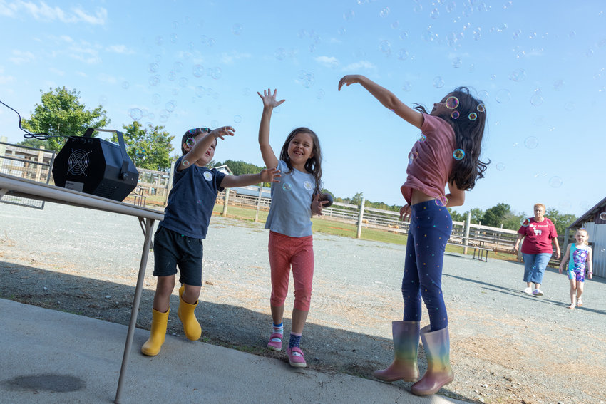 Kids play with bubbles at Carolina Sunshine Alpaca Farm's grand opening event.