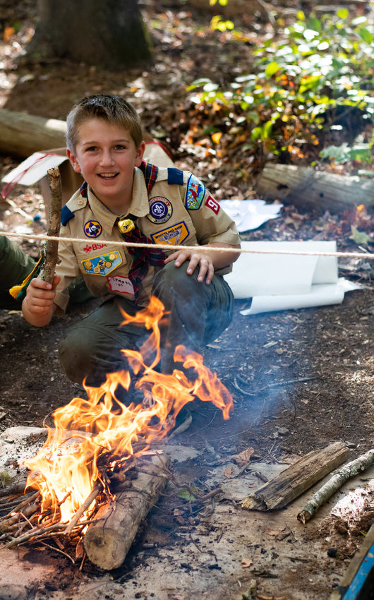 Oliver, a current Eagle Scout from Troop 93, shares his excitement over his win at the fire bulding competition.