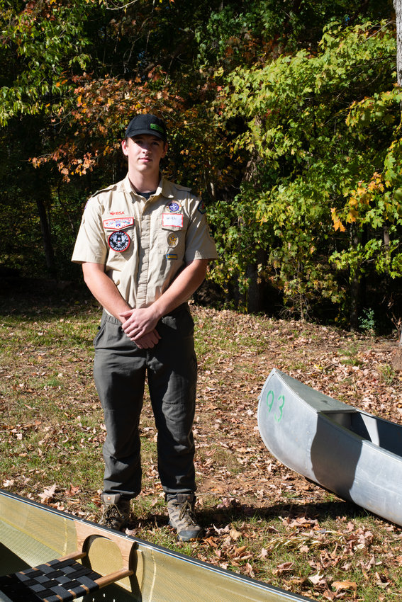 Will Zinn, the Senior Patrol Leader of Troop 93, stands by the canoes at Saturday's event. He says being part of the troop has given him leadership skills that go beyond scouting.