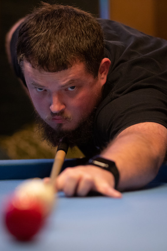 Antonio Sloan, member of the Pittsboro Pool League, eyes his shot during a pool match against Bruce Lively at The Sycamore at Chatham Mills in Pittsboro on Wednesday, Nov. 2, 2022. Sloan won the match.
