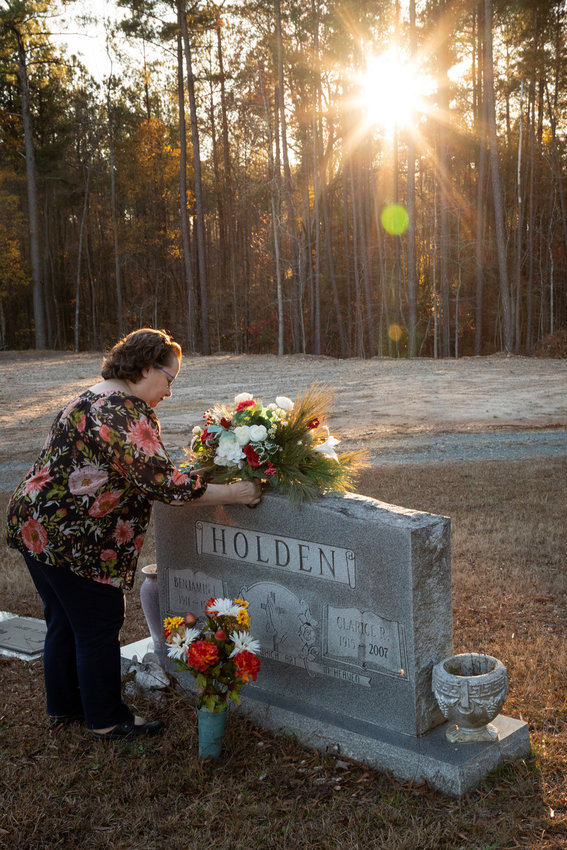 Sharron placed a bouquet of flowers on the gravestone of her grandparents at Merry Oaks Cemetery. Sharron is the third generation in her family to call Merry Oaks home. NCDOT plans show a 12x12 tunnel replacing the current entry and exit to the cemetery, with a raised six-lane road adjacent to the gravesites. “If you start looking at what [the plans] mean,” Sharron said. “The thought of this, and then a short distance, [a six-lane road] in the sky? We stand here and we watch a beautiful sunset. You’re gonna see a [six-lane road].”