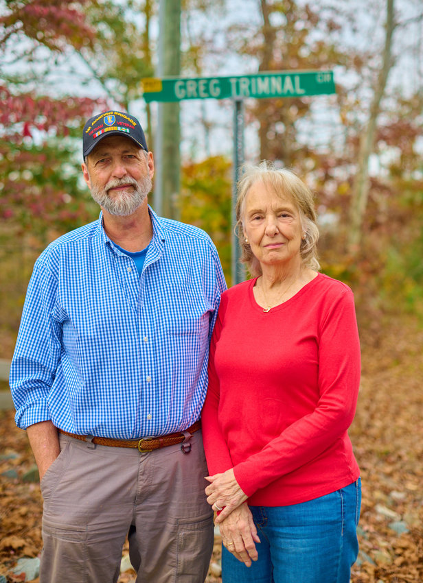 Jim and Marie Vanderbeck pose near their home in Pittsboro, off a road named in memory of Greg Trimnal — who died piloting the helicopter that Vanderbeck might have flown. Also killed in the crash was Vanderbeck's best friend, Jim Mott.