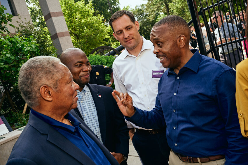 Rep. Robert Reives II (D-Dist. 54), far right, talks with other N.C. politicians at a rally for abortion rights in downtown Raleigh on Saturday.