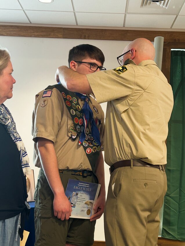 Eagle Scout Zack Wilson is presented with his Eagle pin by his parents, Matt and Amy Wilson.