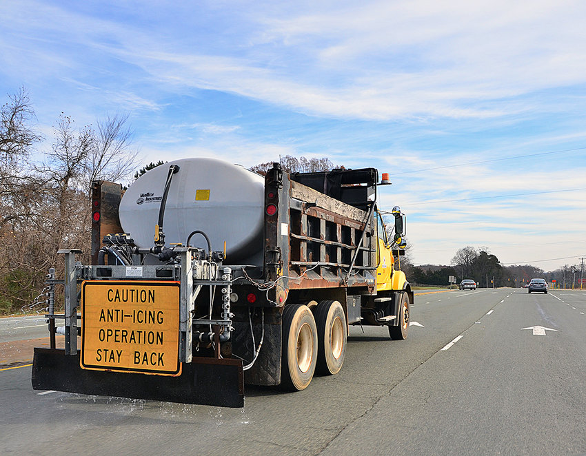A Department of Transportation truck spreads a brine solution on Highway 64. The NCDOT is preparing for a round of wintry precipitation that will begin Sunday and go into Monday morning.
