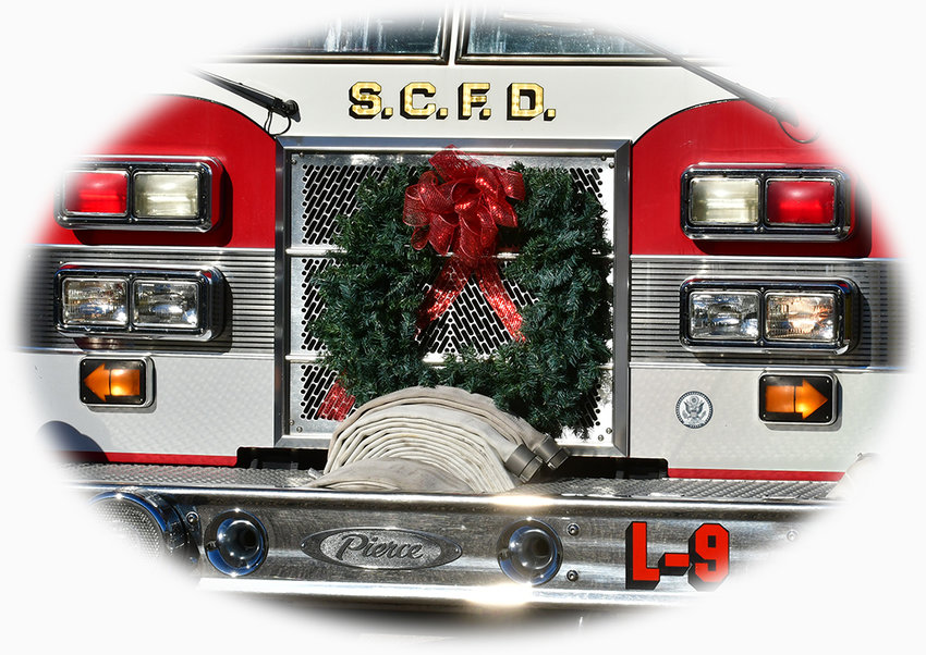 A Christmas wreath hangs proudly on Siler City ladder truck Saturday.