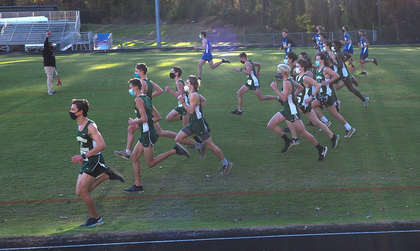 Northwood and Jordan-Matthews men's runners take off at a non-conference cross country meet on Nov. 24 at Northwood High School. Runners wore masks at the start of the race and took them off once they were distanced from others on the course.