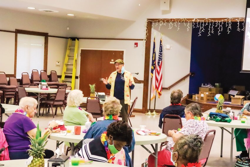 Dennis Streets, the director of Chatham's Council on Aging, greets those who attended a meal at the Western Chatham facility last summer.
