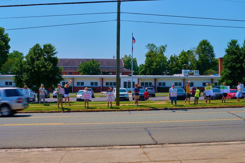 A small protest outside of the Chatham County Schools Board of Education meeting in August, at which the board voted to mandate universal indoor masking.