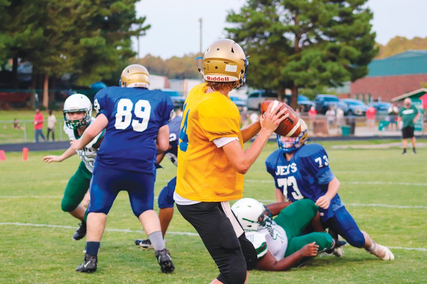 Jordan-Matthews' sophomore quarterback Kelton Fuquay (14) drops back in the pocket while looking for an open receiver during a game at the Jack Shaner Jamboree, hosted by Northwood, last Friday.
