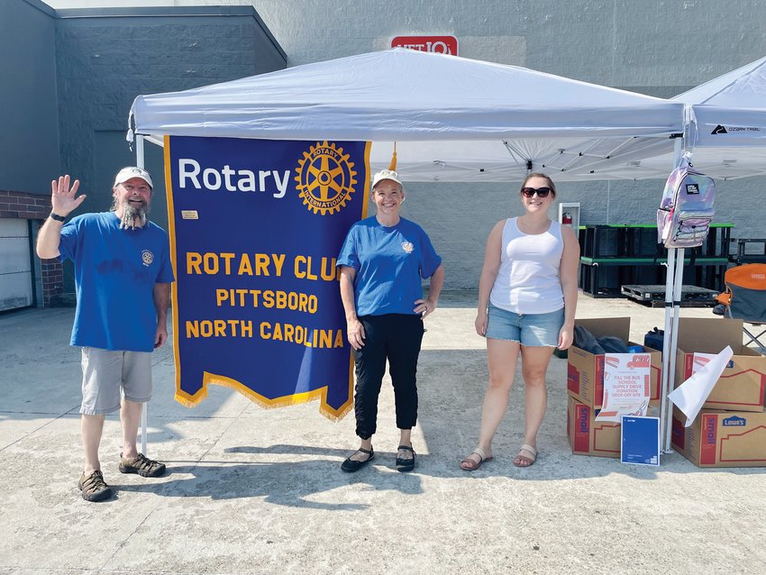 Pittsboro Rotarians pose at Walmart during the club's 'Fill the Bus' effort to collect school supplies for local students.