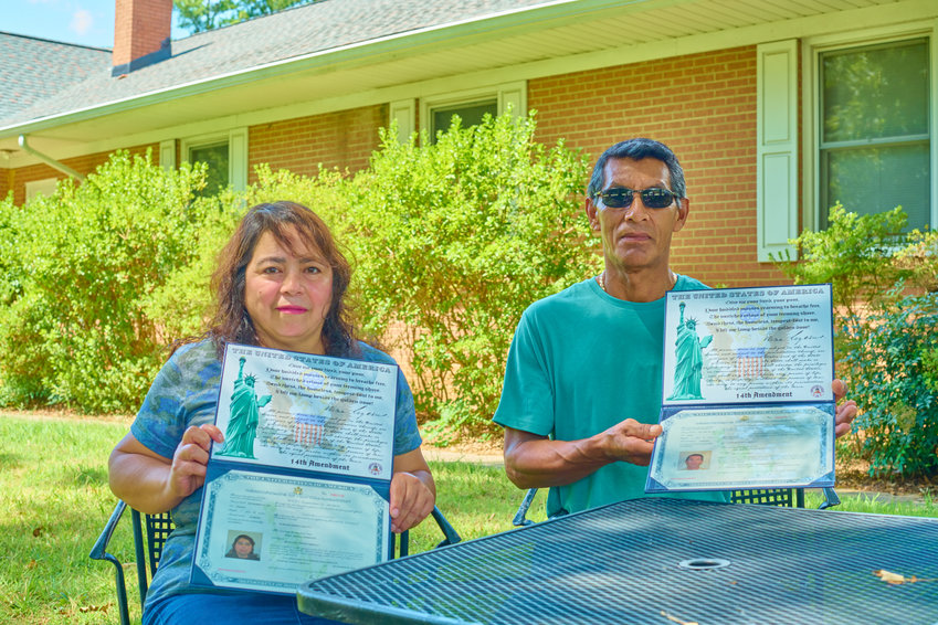 Dora Interiano and her husband Jos&eacute; hold up their U.S. citizenship certificates, which both received last December with the help of Chatham Literacy.