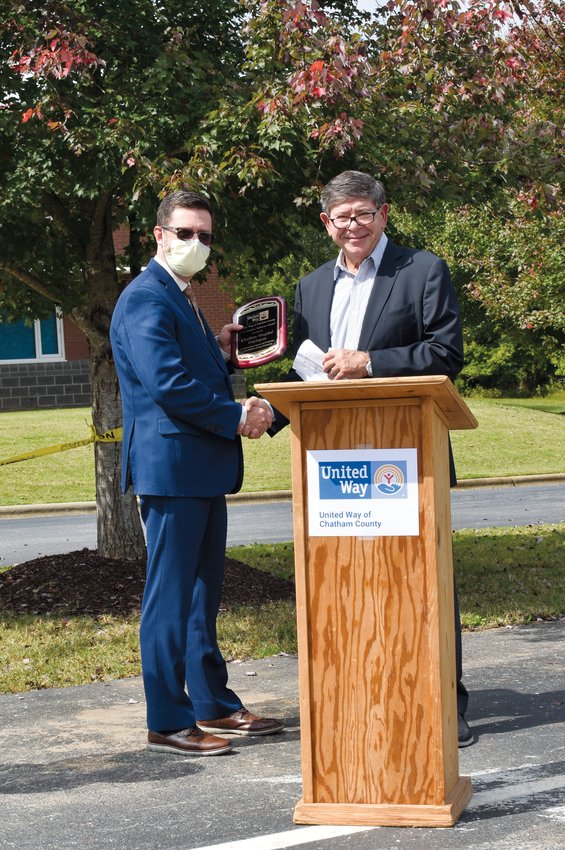 Dr. Jeff Strickler, CEO of Chatham Hospital (left), receives the Chatham County United Way's 2021 Ormsbee Robinson Award. The award, the highest honor given by United Way, was presented last Thursday during an employee appreciation event at Chatham Hospital by United Way board President Dr. Jim Sink (right).