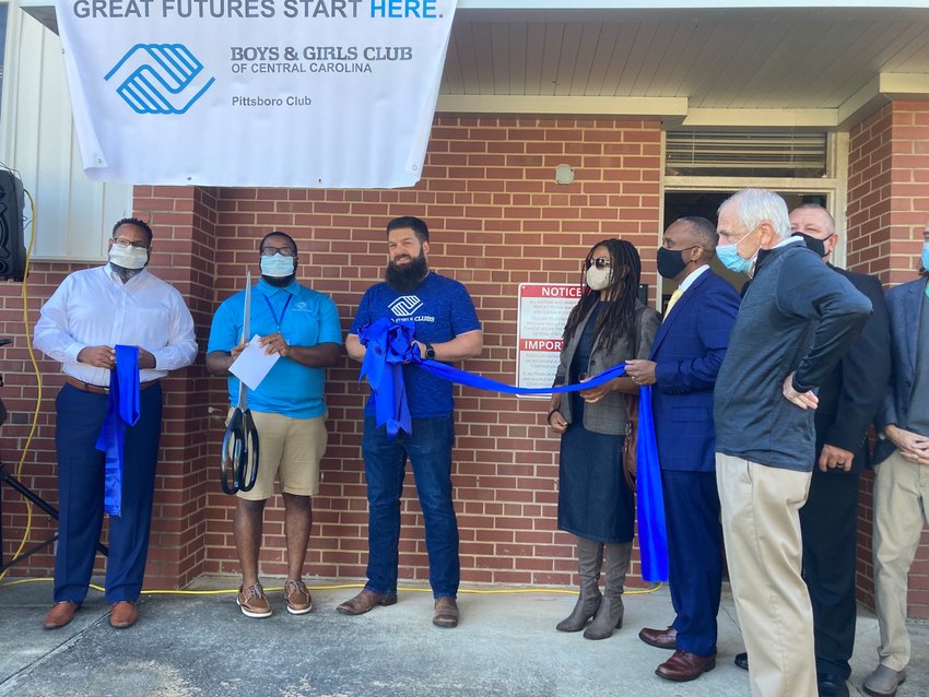 Pittsboro Commissioner Kyle Shipp (center, with beard) and local officials gathered Monday for the official ribbon-cutting of the new Boys &amp; Girls Club of Pittsboro