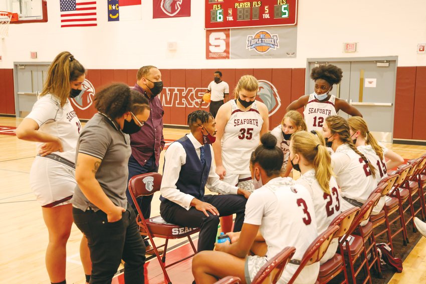 Seaforth head women's basketball coach Charles Byrd (center, in vest) speaks to his team during a timeout in the Hawks' 62-22 blowout win over the Cummings Cavaliers on Dec. 14. Byrd has led his team to a 4-3 record over its first 7 games.