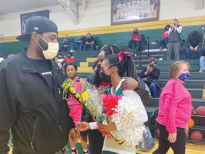Airryn Wharton greets her father, Reginald Wharton Jr., after a recent Northwood basketball game. Airryn was recognized as a 'Humble Hero' for using CPR to save her dad's life.