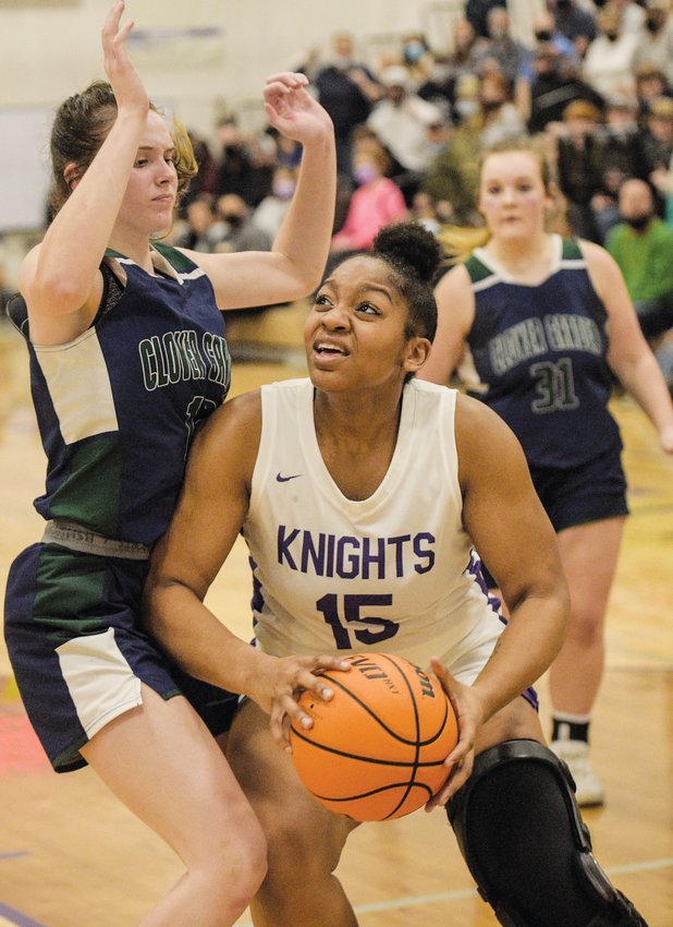 Chatham Charter senior Alexis Baldwin (15) pushes her way into the paint against a Clover Garden defender in the Knights' 53-47 loss to the Grizzlies in the 2nd round of the NCHSAA 1A women's basketball playoffs last Thursday. Baldwin had 9 points and 8 rebounds against the Grizzlies.
