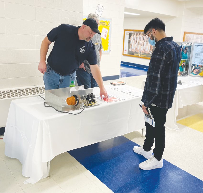 Siler City resident Jos&eacute; Lopez, 26, visits a table at Central Carolina Community College's community career night at Jordan-Matthews High School. Lopez hopes to educate Latino community members about employment opportunities.