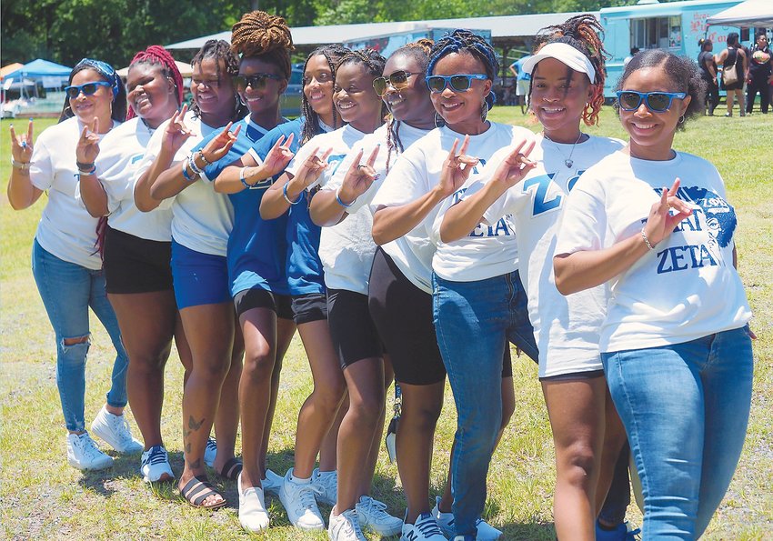 The Zeta Phi Beta sorority performs a step routine at the Pittboro Junteenth celebration on Saturday at the Chatham County Fairgrounds in Pittsboro. The sorority is a part of the Divine Nine, the nine historically Black Greek letter organizations that make up the National Pan-Hellenic Council.