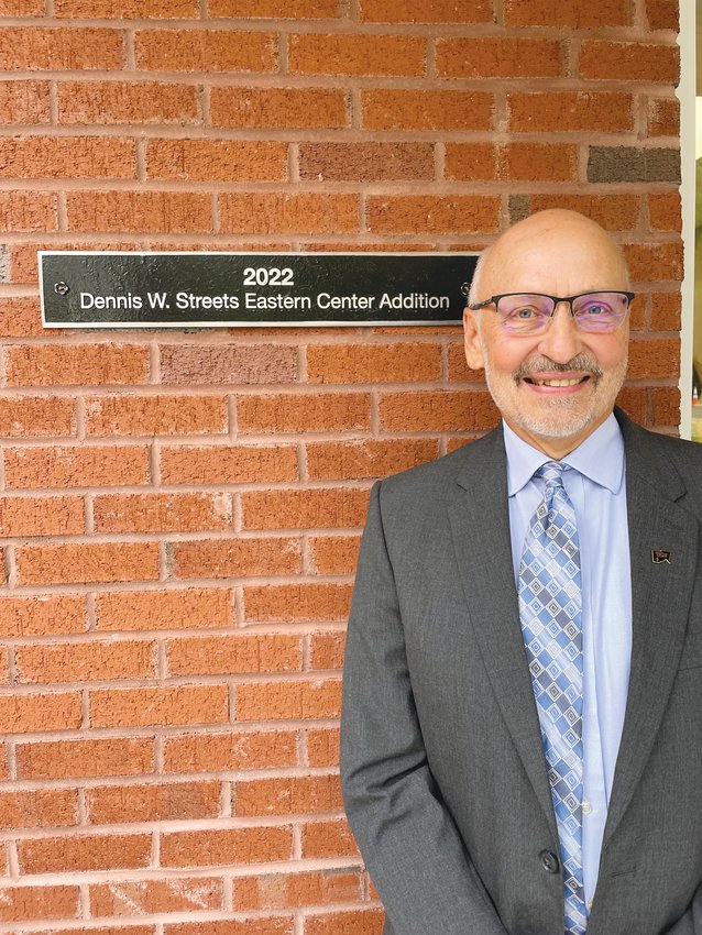 Retired Chatham County Council on Aging Director Dennis Streets stands next to the plaque proclaiming the Eastern Chatham Senior Center addition as the &lsquo;Dennis W. Streets Eastern Center Addition&rsquo; last Friday in Pittsboro.