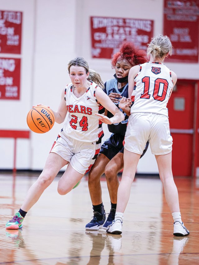 Chatham Central junior Katherine Gaines (24) dribbles past a screen set by teammate Kailey Green during the first round of the state playoffs.