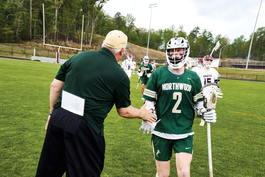 Northwood senior Will Smith (2) greets head coach Randy Cox after the Chargers' 18-7 win over Seaforth last Thursday.