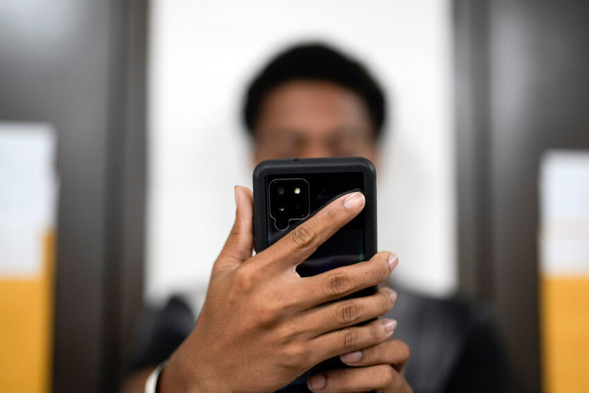 FILE - A man using a phone. (AP Photo/Gregory Bull, File)
