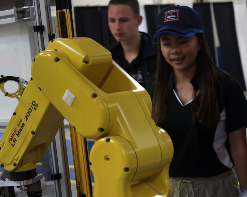Students examine a Fanuc industrial robot at CCCC&rsquo;s National Manufacturing Day showcase.