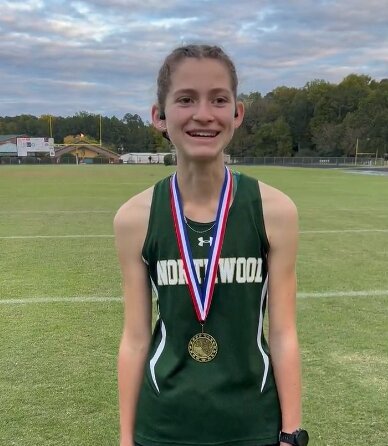 Northwood&rsquo;s Sydney Gray poses with her first-place medal after the Mid-Carolina 1A/2A Conference cross country championship.