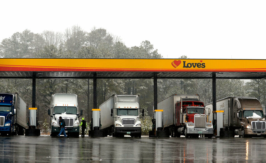 FILE - In this Feb. 11, 2014, file photo, truck drivers stop at a gas station to fill up their tractor trailer rigs. (AP Photo/David Tulis, File)