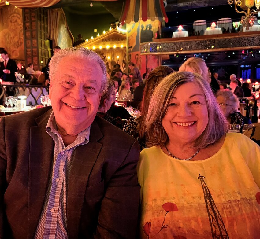 Erika Hoffman, a former schoolteacher in Chatham County Schools, with her husband, Dr. Byron Hoffman, at Moulin Rouge in Paris.