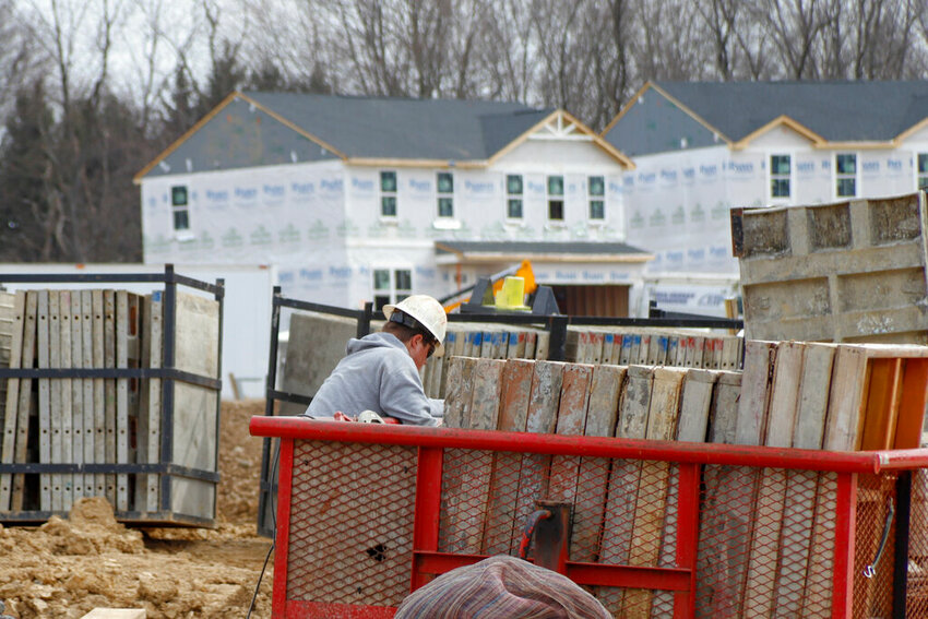 Construction continues at a housing plan in Zelienople, Pa., Wednesday, March 18, 2020.