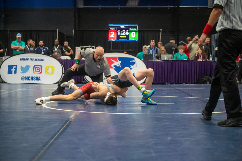 Seaforth&rsquo;s Gabe Rogers gets the pin over Trinity&rsquo;s Aiden Burkholder in the 106-lbs weight class during the 2A NCHSAA Dual Meet Championship at the Greensboro Field House. Rogers&rsquo; win tied the match, but the Hawks eventually fell, 36-31.