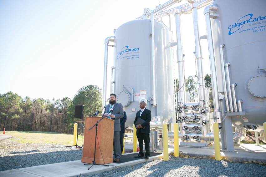 Pittsboro Mayor Kyle Shipp speaks about the new granular activated carbon advanced filtration system, with House Minority Leader Rep. Robert Reives (D) on the right, at the Pittsboro Water Treatment Facility on Thursday, Feb. 15.  (Ena Sellers | Chatham News &amp; Record)