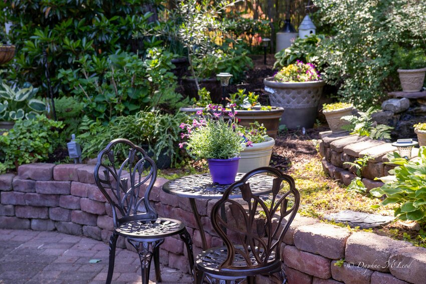 The Yost&rsquo;s backyard patio is framed with lush plantings and containers brimming with bright spring color.