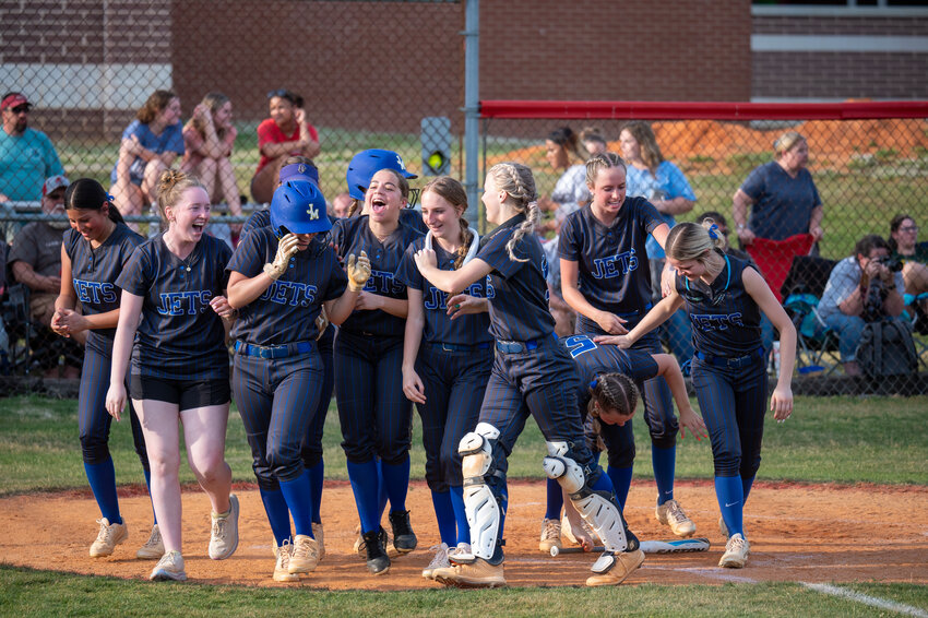 Jordan-Matthews' Marcy Clark is greeted my her teammates after hitting a home run during the Mid-Carolina Conference Championship at Graham High School in Burlington, NC on May 3, 2024.