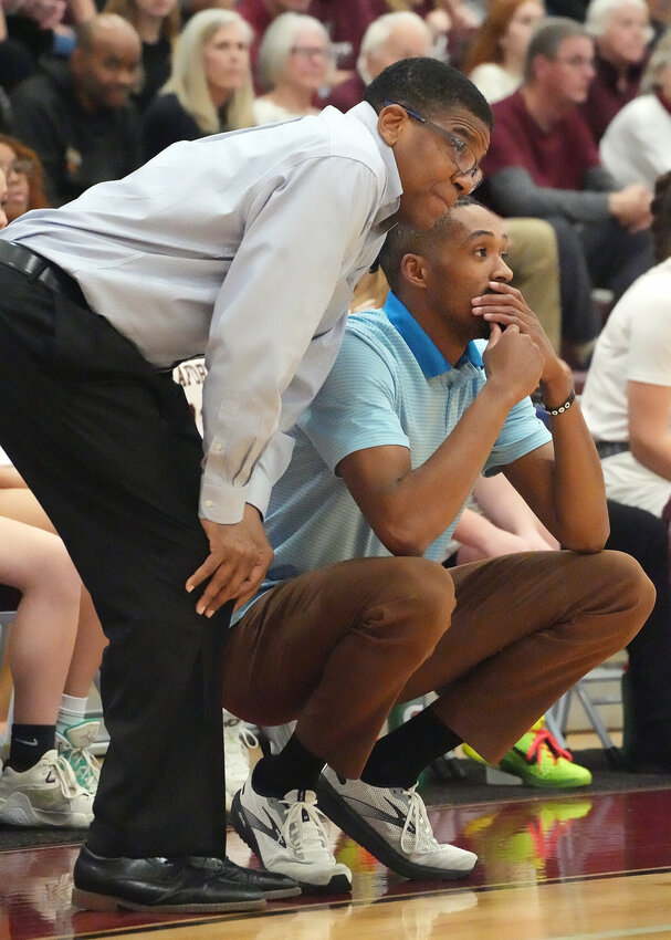 John Berry (standing) and Seaforth girls' varsity basketball head coach Charles Byrd watch as the Hawks battle St. Pauls on March 8.