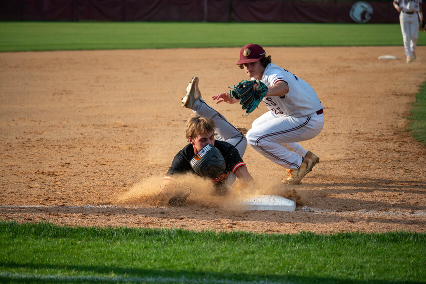 Wallace-Rose Hill&rsquo;s Kaiden Liv sides into third base safe as Seaforth&rsquo;s Jaedyn Rader drops the ball during the first round of the 2A East NCHSAA playoffs at Seaforth High School in Pittsboro, NC on May 7, 2024.