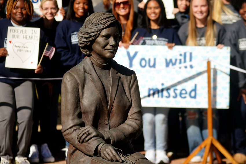 Students watch as family members participate in a wreath laying ceremony to honor former first lady Rosalynn Carter at the Rosalynn Carter Health & Human Services complex on the campus of Georgia Southwestern State University, Monday, Nov. 27, 2023, in Americus, Ga. (AP Photo/John Bazemore, Pool)