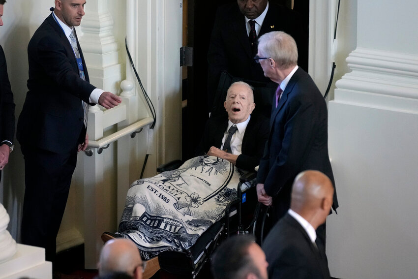 Former President Jimmy Carter arrives to attend a tribute service for his wife and former first lady Rosalynn Carter, at Glenn Memorial Church, Tuesday, Nov. 28, 2023, in Atlanta. (AP Photo/Andrew Harnik)