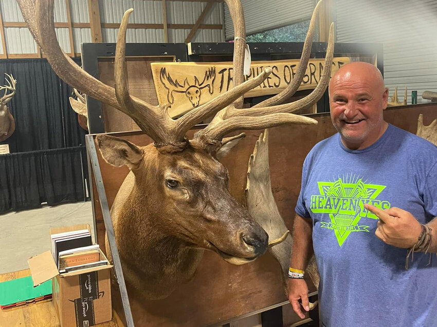 Chris McDaniel, a founding member of the country music band Confederate Railroad, poses with an elk mount he displays when he preaches at church-sponsored wild game dinners. McDaniel has introduced some 2,700 people to Christ through his ministry so far this year. (Photo/Chris McDaniel Ministries)