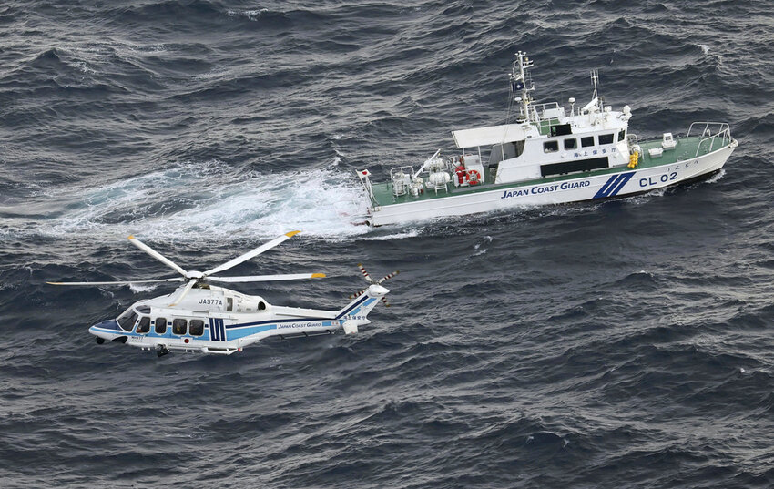A Japanese coast guard helicopter and patrol vessel conduct search and rescue operation in the waters where a U.S. military Osprey aircraft crashed off the coast of Yakushima Island, southern Japan Thursday, Nov. 30, 2023. (Kyodo News via AP)