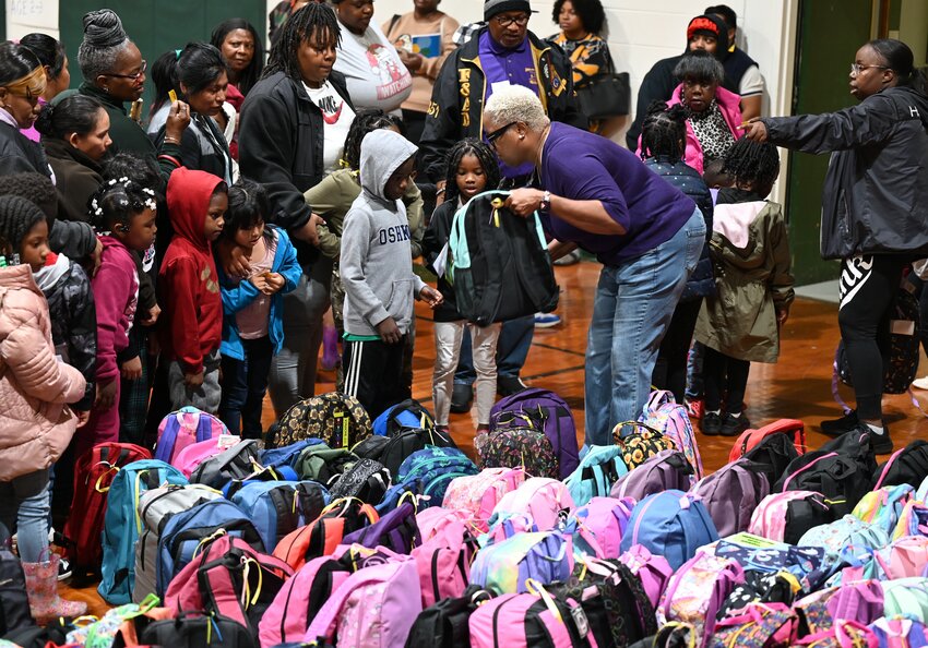 Children line up to get backpacks filled with Christmas goodies in Dawson, Ga., on Saturday, December 2, 2023. (Index/Roger Alford)