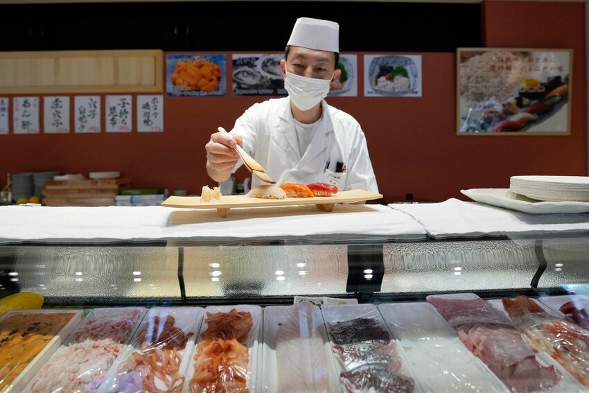A sushi chef prepares a plate at the Toyosu Market on Monday, Jan. 29, 2024, in Tokyo. (AP Photo/Eugene Hoshiko, File)