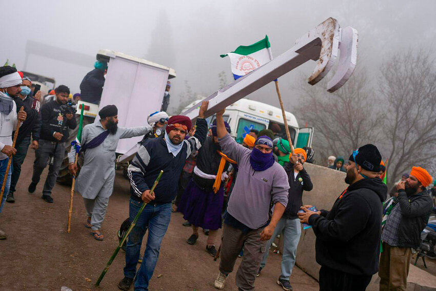 Indian farmers who have been protesting for a week to demand guaranteed crop prices wait to march to the capital near Shambhu border that divides northern Punjab and Haryana states, some 120 miles from New Delhi, India, Wednesday, Feb. 21, 2024. (AP Photo/Altaf Qadri)