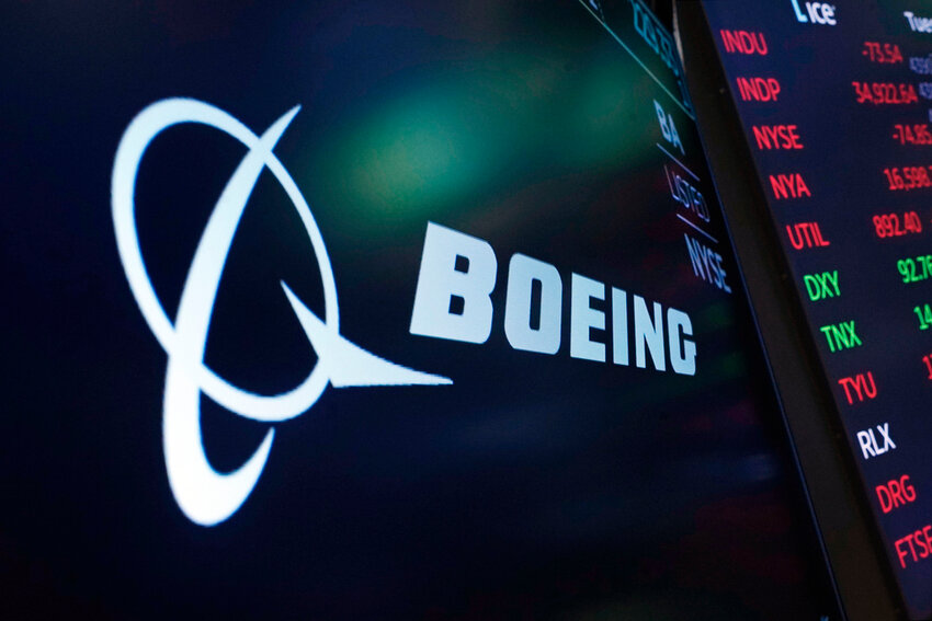 The logo for Boeing appears on a screen above a trading post on the floor of the New York Stock Exchange, July 13, 2021. (AP Photo/Richard Drew, File)