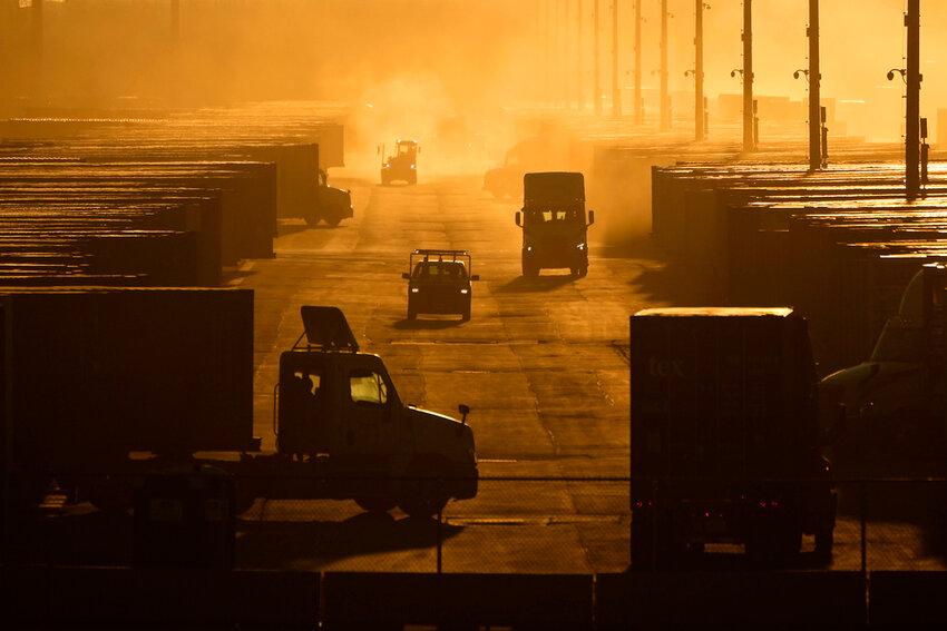 Workers drive among shipping containers and trailers at a BNSF intermodal terminal, Jan. 3, 2024, in Edgerton, Kan. (AP Photo/Charlie Riedel)