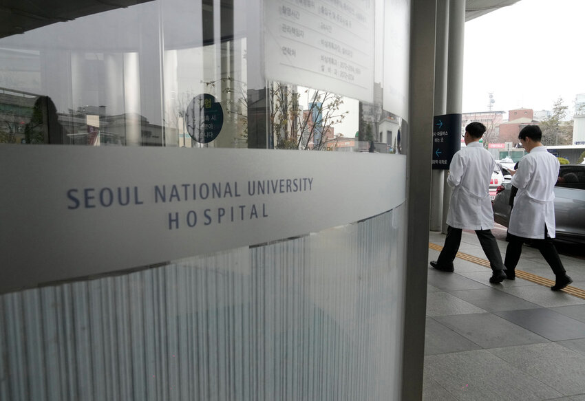 Medical workers walk to enter Seoul National University Hospital in Seoul, South Korea, Thursday, Feb. 29, 2024. (AP Photo/Ahn Young-joon)